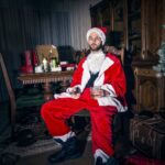 Man in Santa Claus Costume Sitting on Wooden Chair