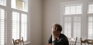 I GUESS I SHOULD PLAY FRISBEE OR BUY AN ICE CREAM Photo of Man Leaning on Wooden Table